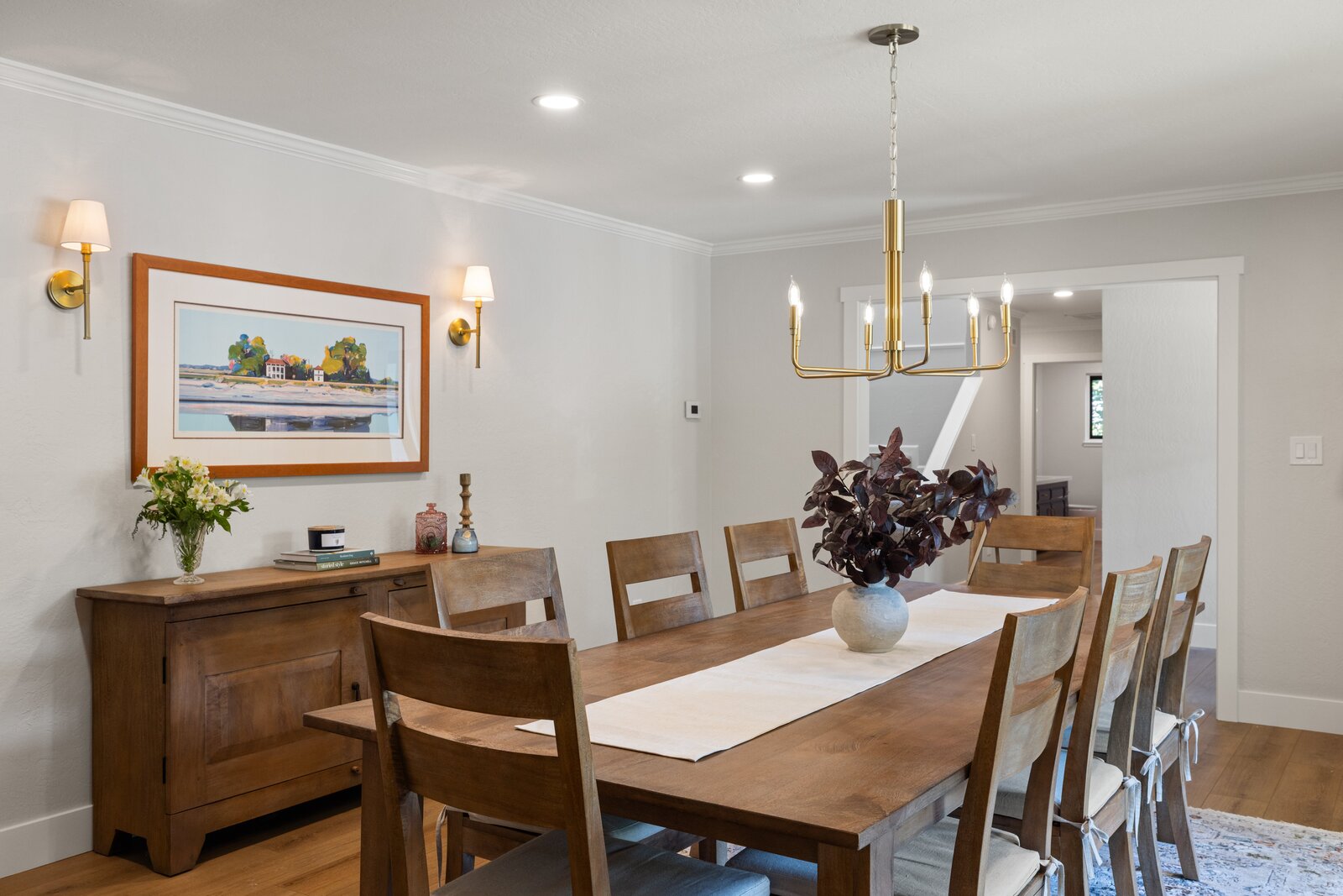 Dining room remodel in Sacramento, CA with crystal chandelier, wood table, and sliding glass doors