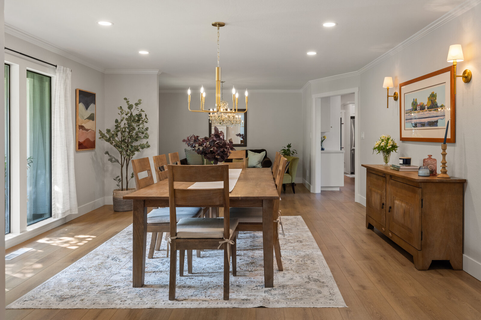 Dining room remodel in Sacramento, CA with wood table, brass chandelier, and wood sideboard