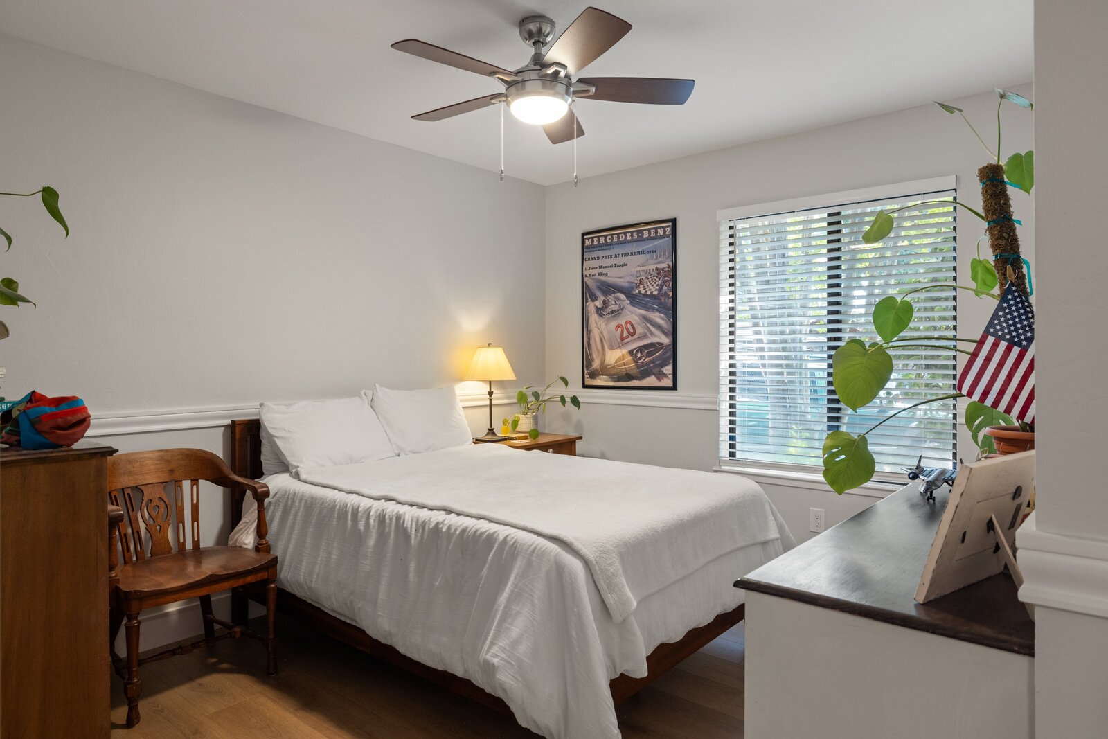 Guest bedroom remodel in Sacramento, CA with wood furniture and vintage travel poster
