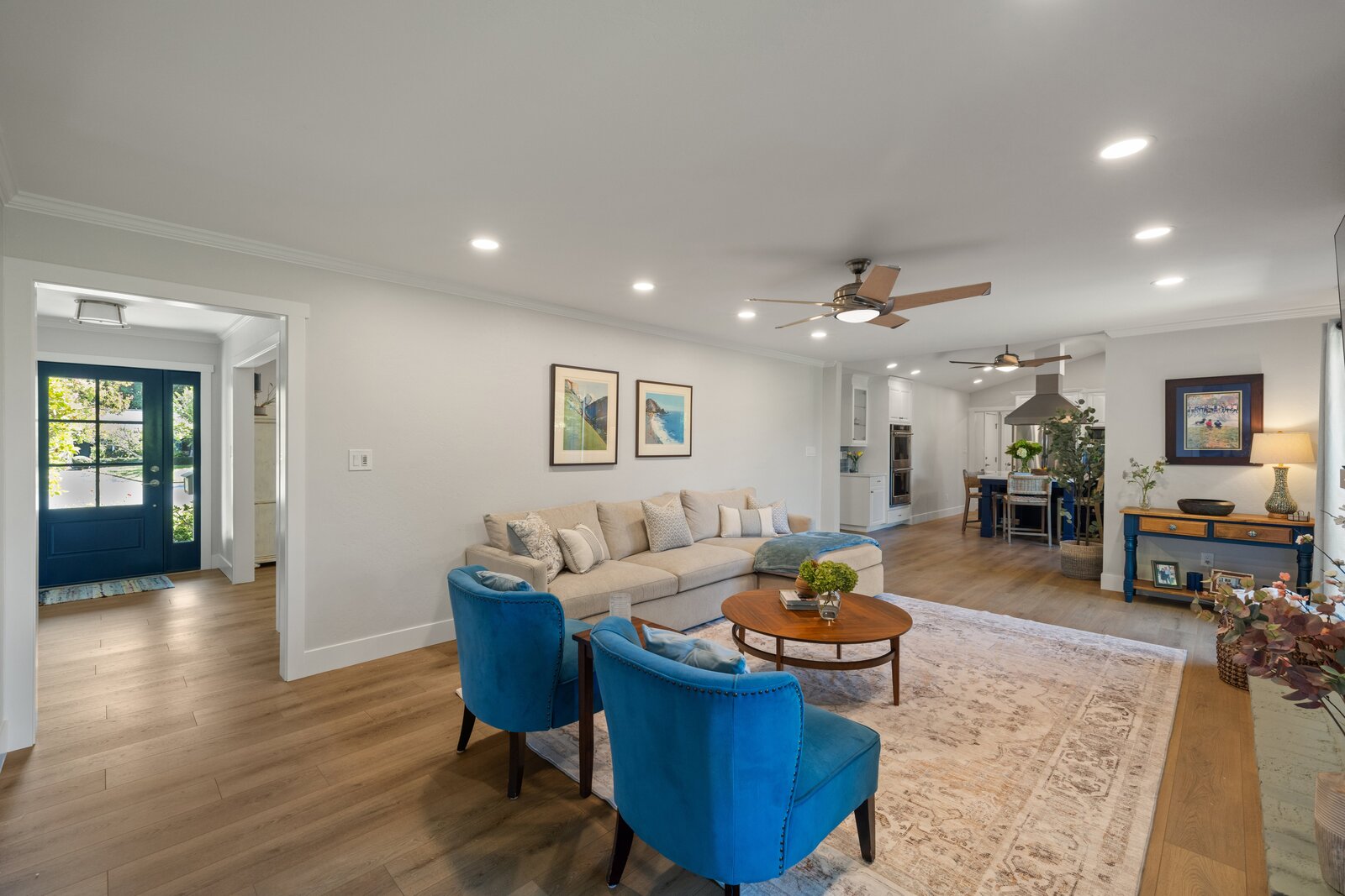 Living room remodel in Sacramento, CA with sectional sofa, blue chairs, and navy front door view Living room remodel in Sacramento, CA with sectional sofa, blue chairs, and navy front door view