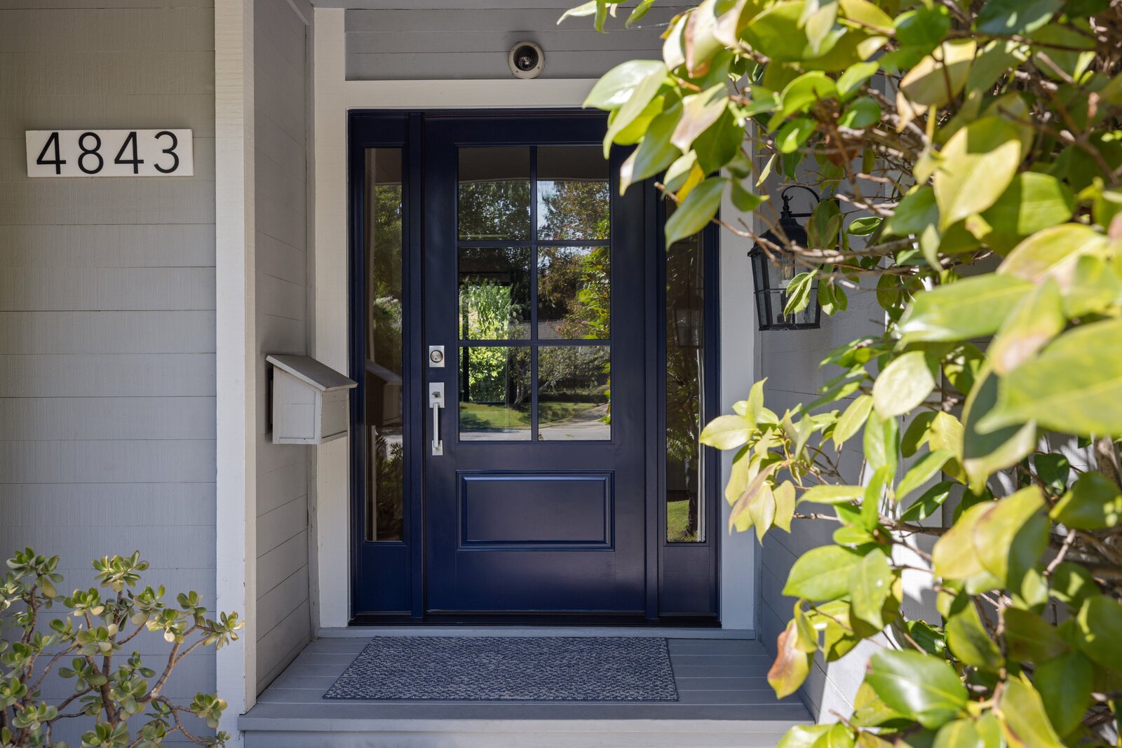 Remodeled home entrance in Sacramento, CA featuring a navy blue front door