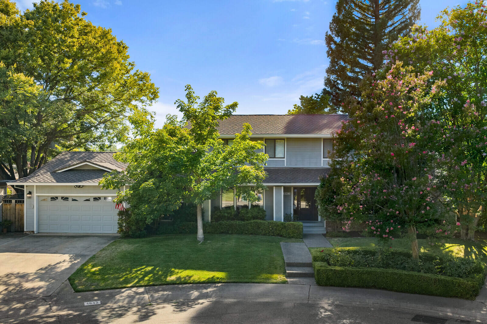 Remodeled two story home exterior in Sacramento, CA with lush front yard landscaping