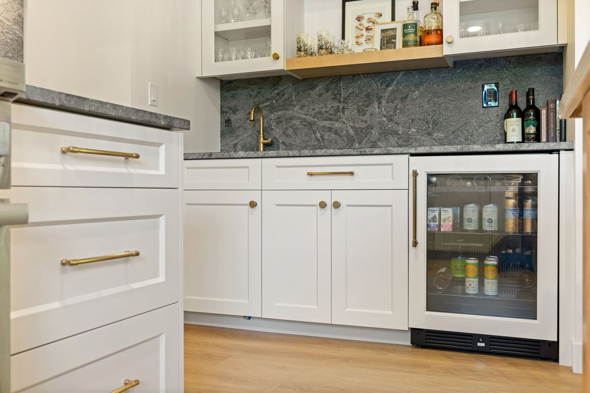 Bar nook by H&H Builds in Sacramento with wine fridge, gold faucet, and elegant shaker cabinetry