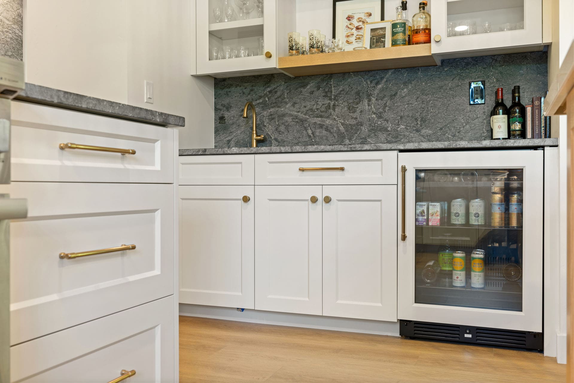 Bar nook by H&H Builds in Sacramento with wine fridge, gold faucet, and elegant shaker cabinetry Bar nook by H&H Builds in Sacramento with wine fridge, gold faucet, and elegant shaker cabinetry