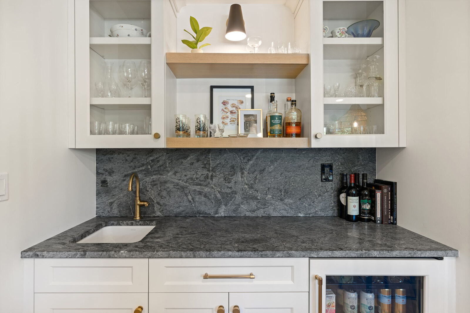 Kitchen bar nook in Sacramento, CA remodel with glass cabinets and wine storage