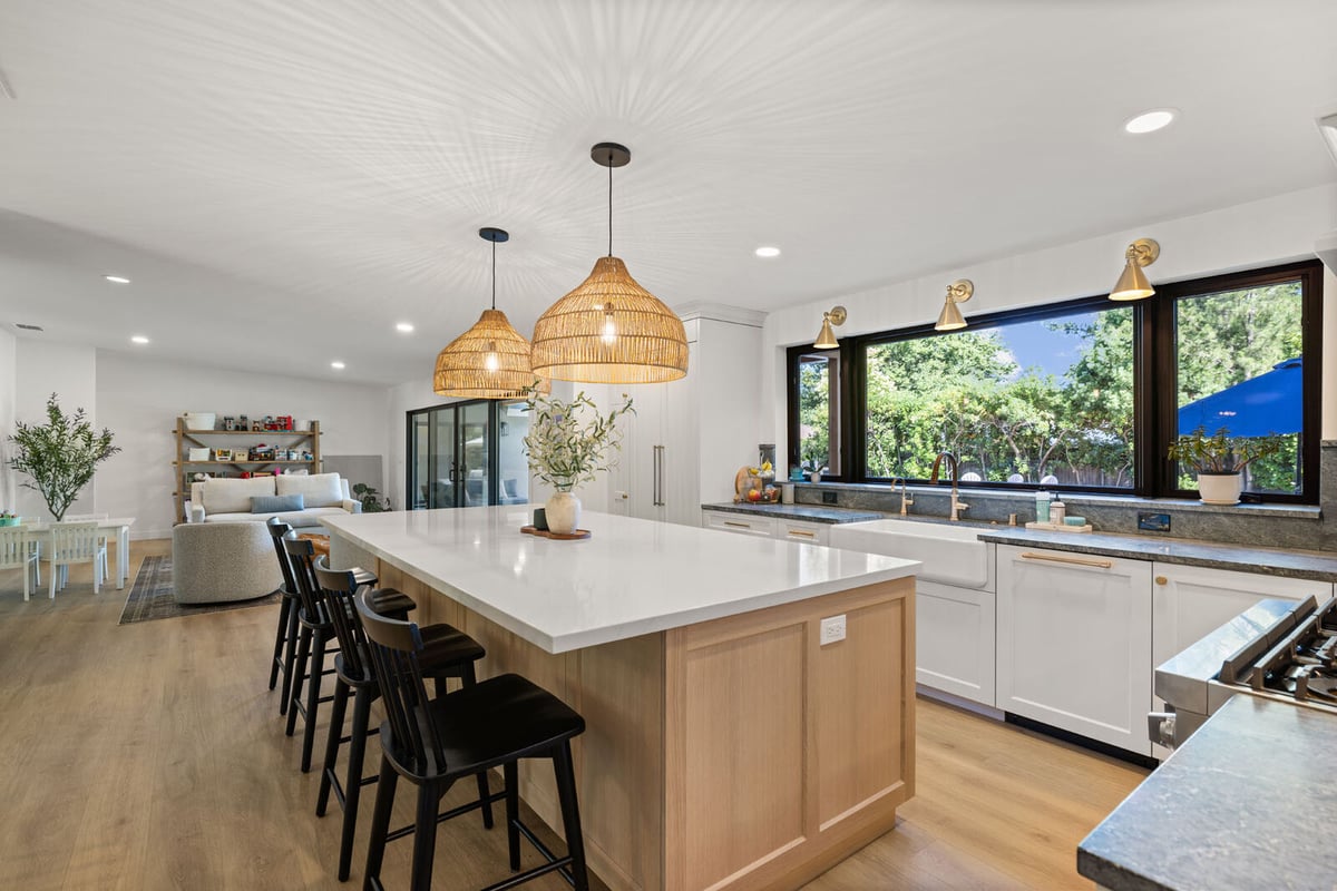 Open concept kitchen in Sacramento, CA with island seating and black barstools