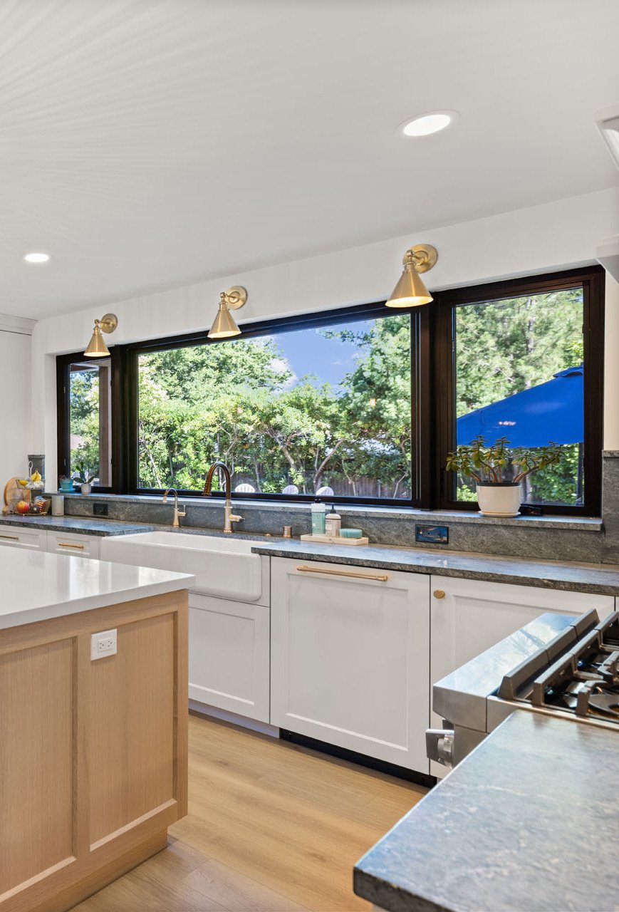 Sacramento kitchen with farmhouse sink, large picture windows, quartz island, and modern finishes