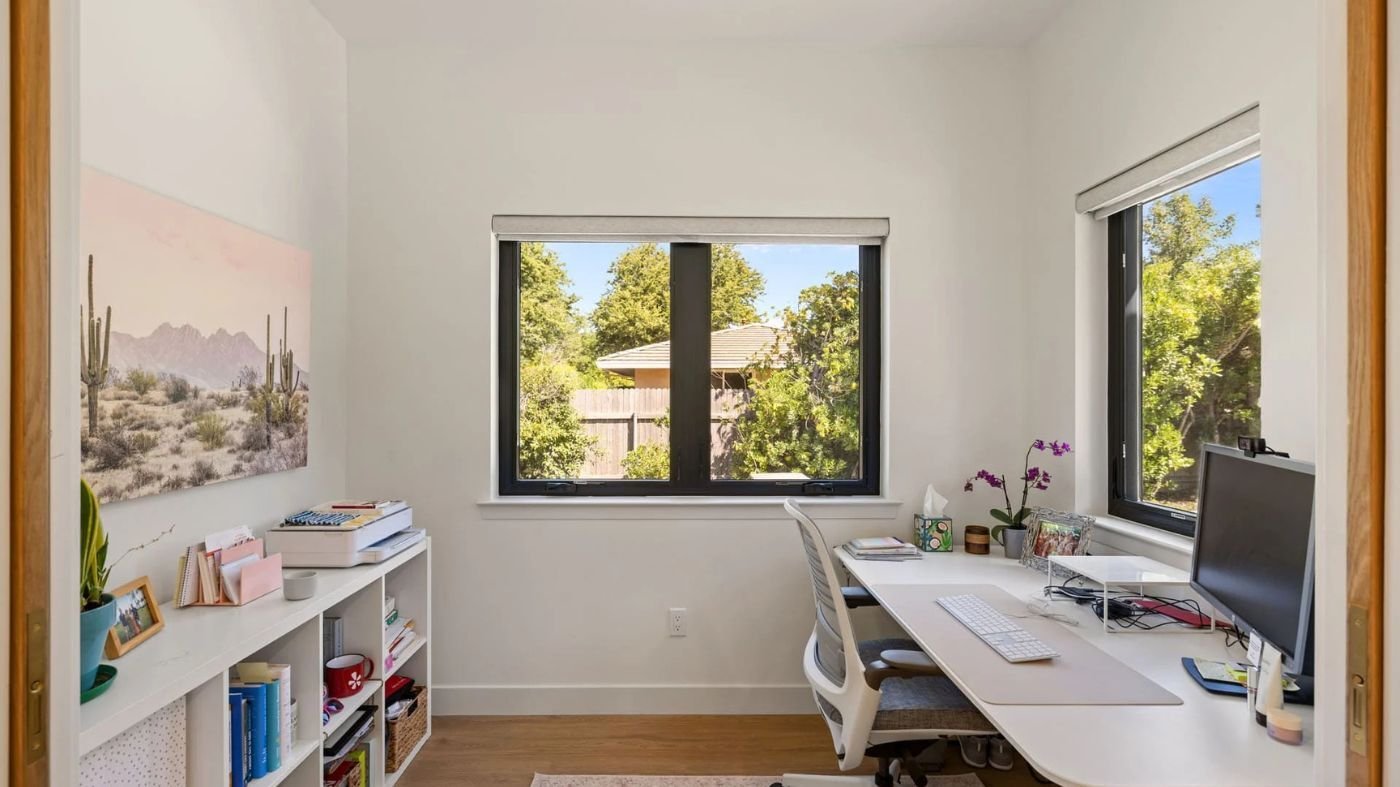 Small home office by H&H Builds in Sacramento with corner desk, open shelving, and window views Small home office by H&H Builds in Sacramento with corner desk, open shelving, and window views