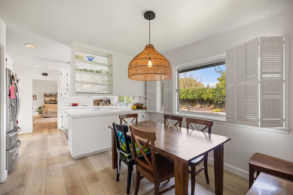 BEFORE Sacramento kitchen with white tile counters, wood dining table, and woven pendant over breakfast nook