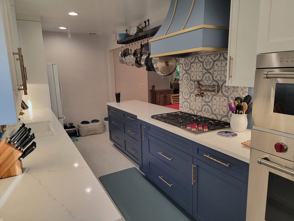 Elegant kitchen renovation with blue cabinetry and custom tile backsplash in Sacramento, CA by H&H Builds