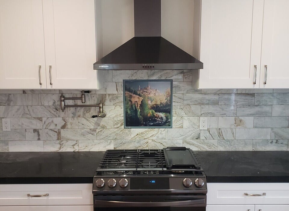 Modern kitchen remodel with white cabinets, black countertops, and a stainless steel hood by H&H Builds in Sacramento, CA