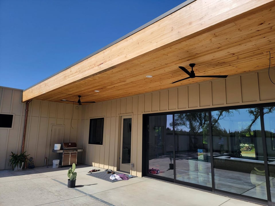 Custom covered patio remodel featuring wooden ceilings, ceiling fans, and stylish outdoor decor by H&amp;H Builds in Sacramento, CA