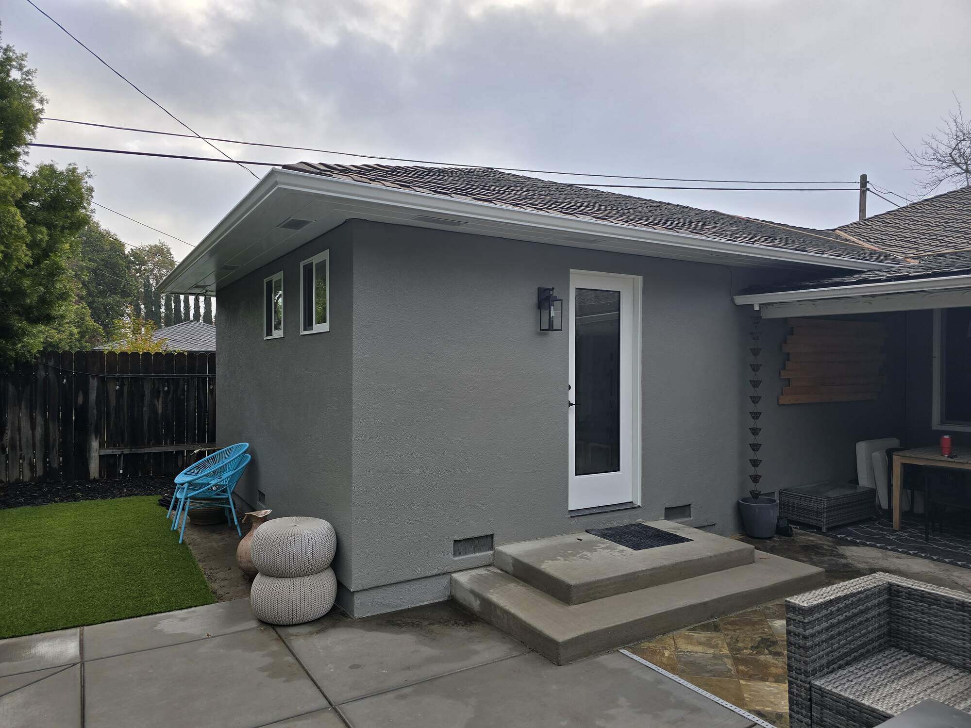 Gray guest house addition with white trim and a modern backdoor in Sacramento, CA, by H&H Builds