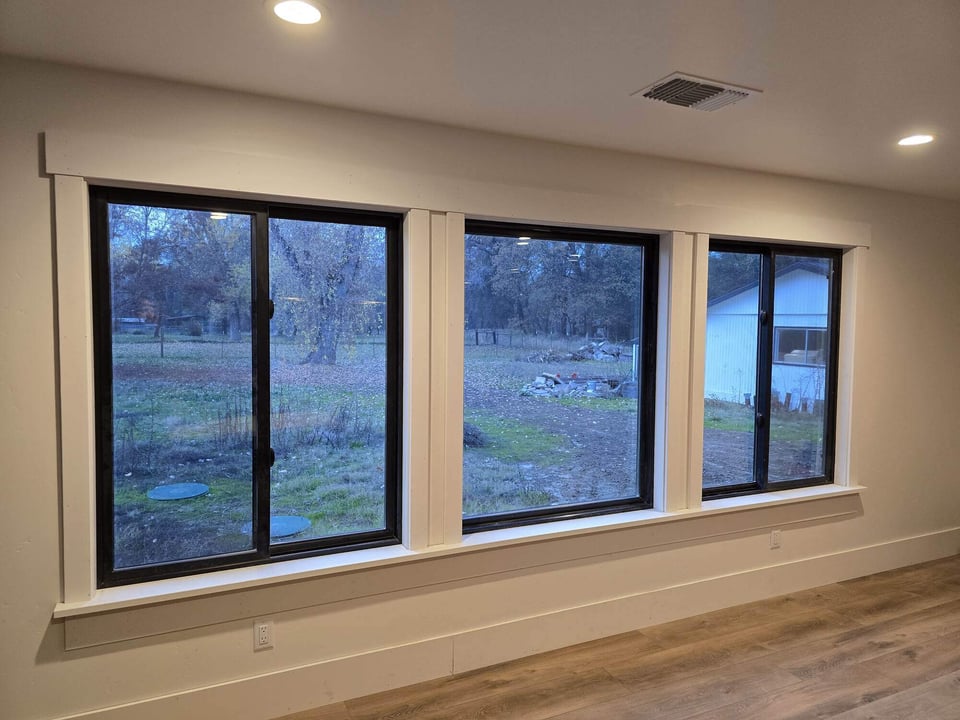 Renovated room with large windows showcasing a backyard landscape by H&H Builds in Sacramento, CA