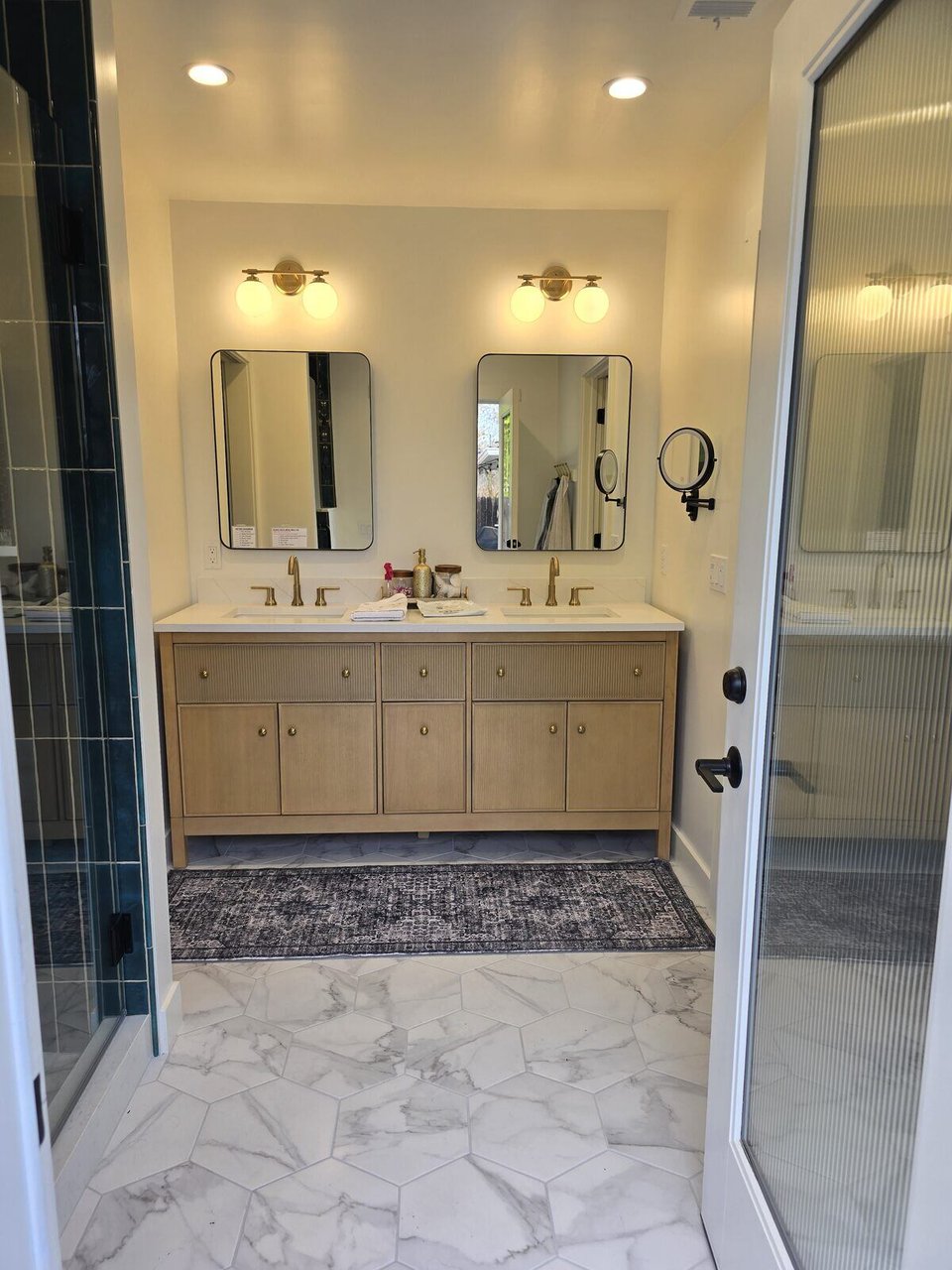Modern bathroom remodel featuring marble hexagonal flooring, double vanity, and glass shower door by H&amp;H Builds, Sacramento, CA