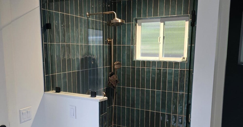 Walk-in shower remodel with green tile walls, bench seating, and window by H&H Builds, Sacramento, CA
