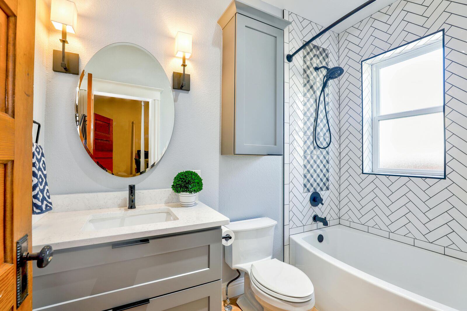 Bright and elegant bathroom remodel by H&H Builds in Sacramento, CA, showcasing a herringbone tile shower and modern vanity Bright and elegant bathroom remodel by H&H Builds in Sacramento, CA, showcasing a herringbone tile shower and modern vanity