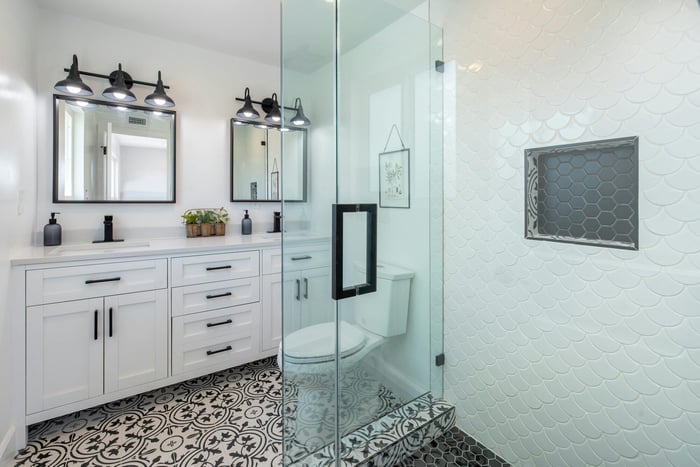 Chic bathroom remodel featuring decorative tile flooring and glass-enclosed shower by H&H Builds in Sacramento, CA Chic bathroom remodel featuring decorative tile flooring and glass-enclosed shower by H&H Builds in Sacramento, CA