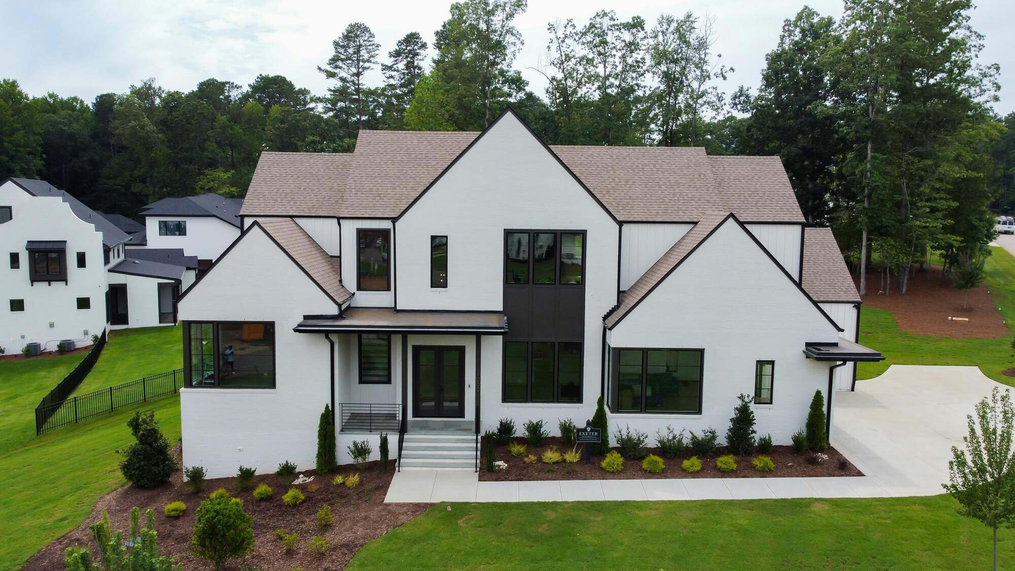 Stunning white modern farmhouse-style custom home with large windows and manicured landscaping by H&H Builds in Sacramento, CA Stunning white modern farmhouse-style custom home with large windows and manicured landscaping by H&H Builds in Sacramento, CA