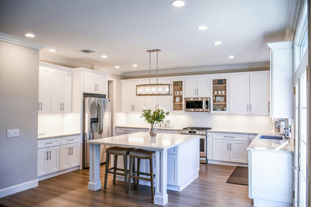 Contemporary kitchen remodel with white cabinetry, stainless steel appliances, and a center island by H&H Builds in Sacramento, CA