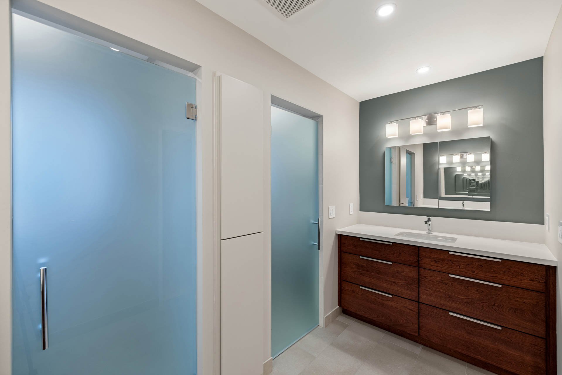 Updated Sacramento bathroom with modern vanity, white countertop, and frosted glass shower and door