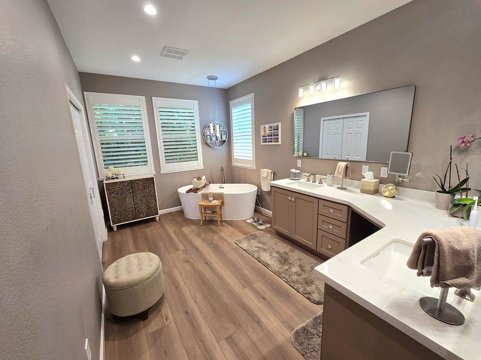 Remodeled Sacramento bathroom with soaking tub, dual vanity, and wood-look flooring