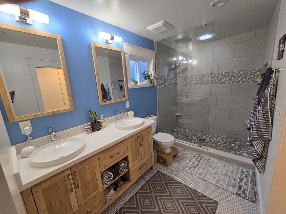 Remodeled bathroom in Sacramento with light wood double vanity.