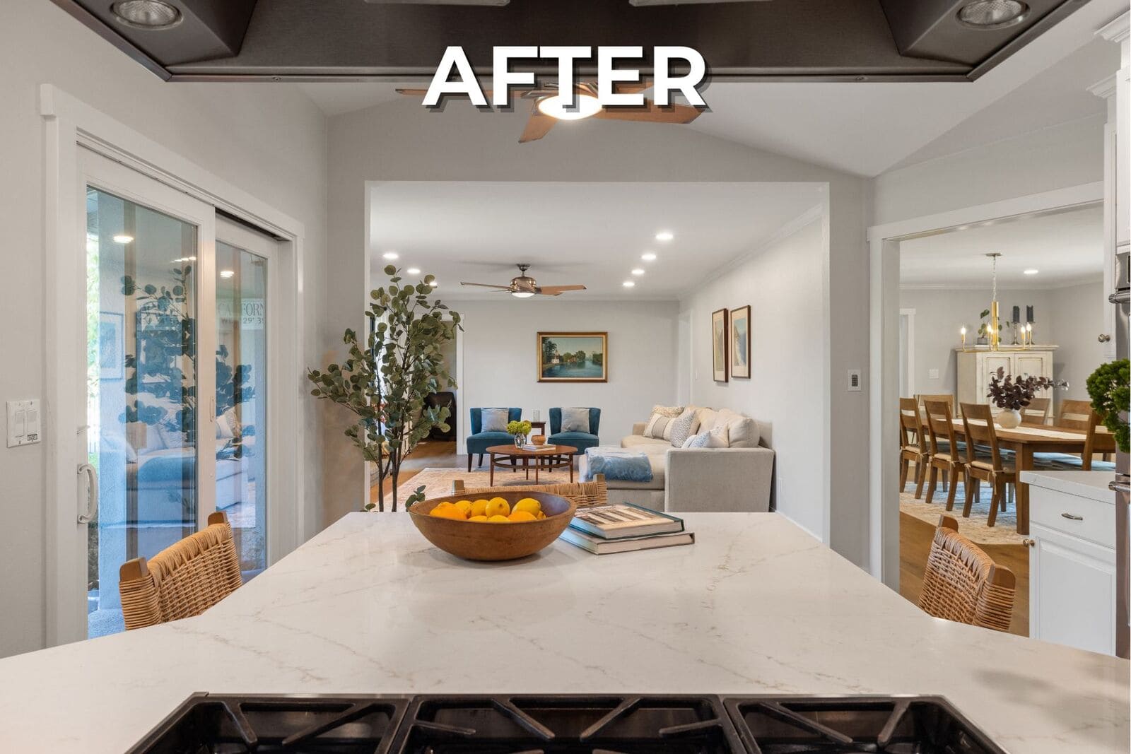 After - Open kitchen with large white quartz island, woven seating, and wide views into the remodeled living and dining spaces. After - Open kitchen with large white quartz island, woven seating, and wide views into the remodeled living and dining spaces.