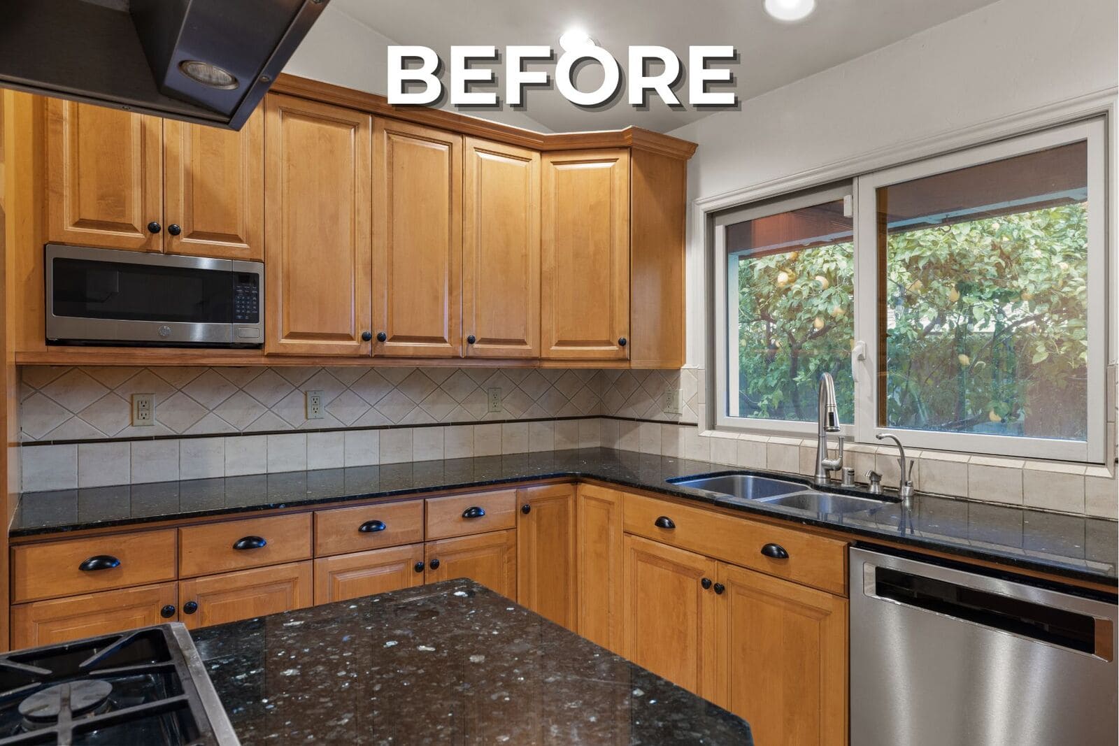 Before - Dated kitchen with honey wood cabinets, dark counters, tiled backsplash, stainless appliances, and a large window. Before - Dated kitchen with honey wood cabinets, dark counters, tiled backsplash, stainless appliances, and a large window.