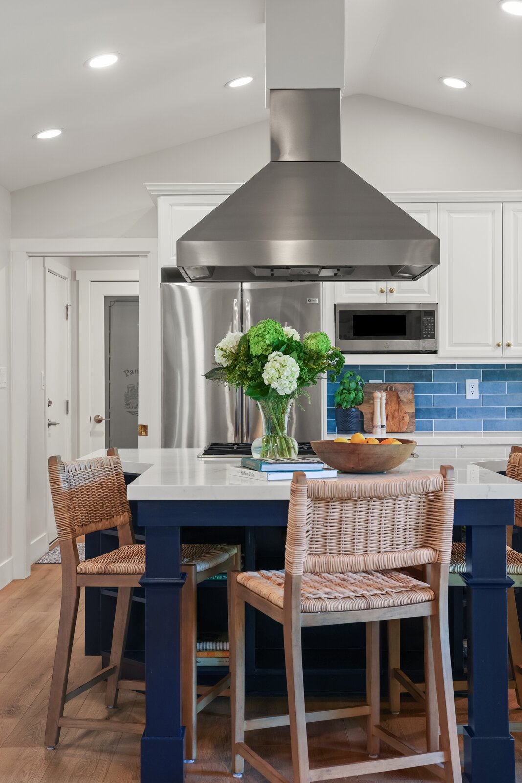 Kitchen remodel in Sacramento, CA with navy island, stainless hood, and blue tile backsplash Kitchen remodel in Sacramento, CA with navy island, stainless hood, and blue tile backsplash