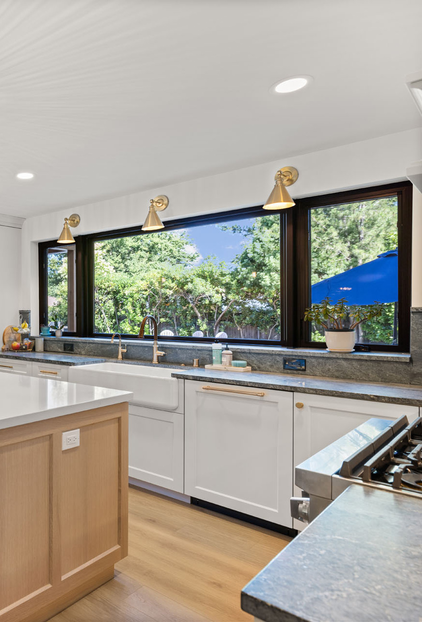 Sacramento kitchen with farmhouse sink, large picture windows, quartz island, and modern finishes Sacramento kitchen with farmhouse sink, large picture windows, quartz island, and modern finishes