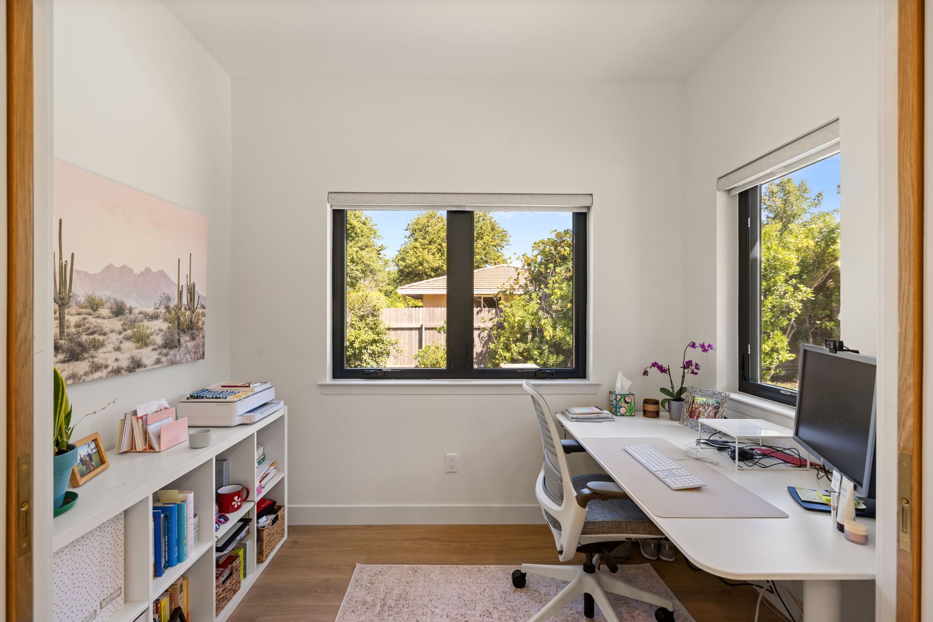 Small home office by H&H Builds in Sacramento with corner desk, open shelving, and window views