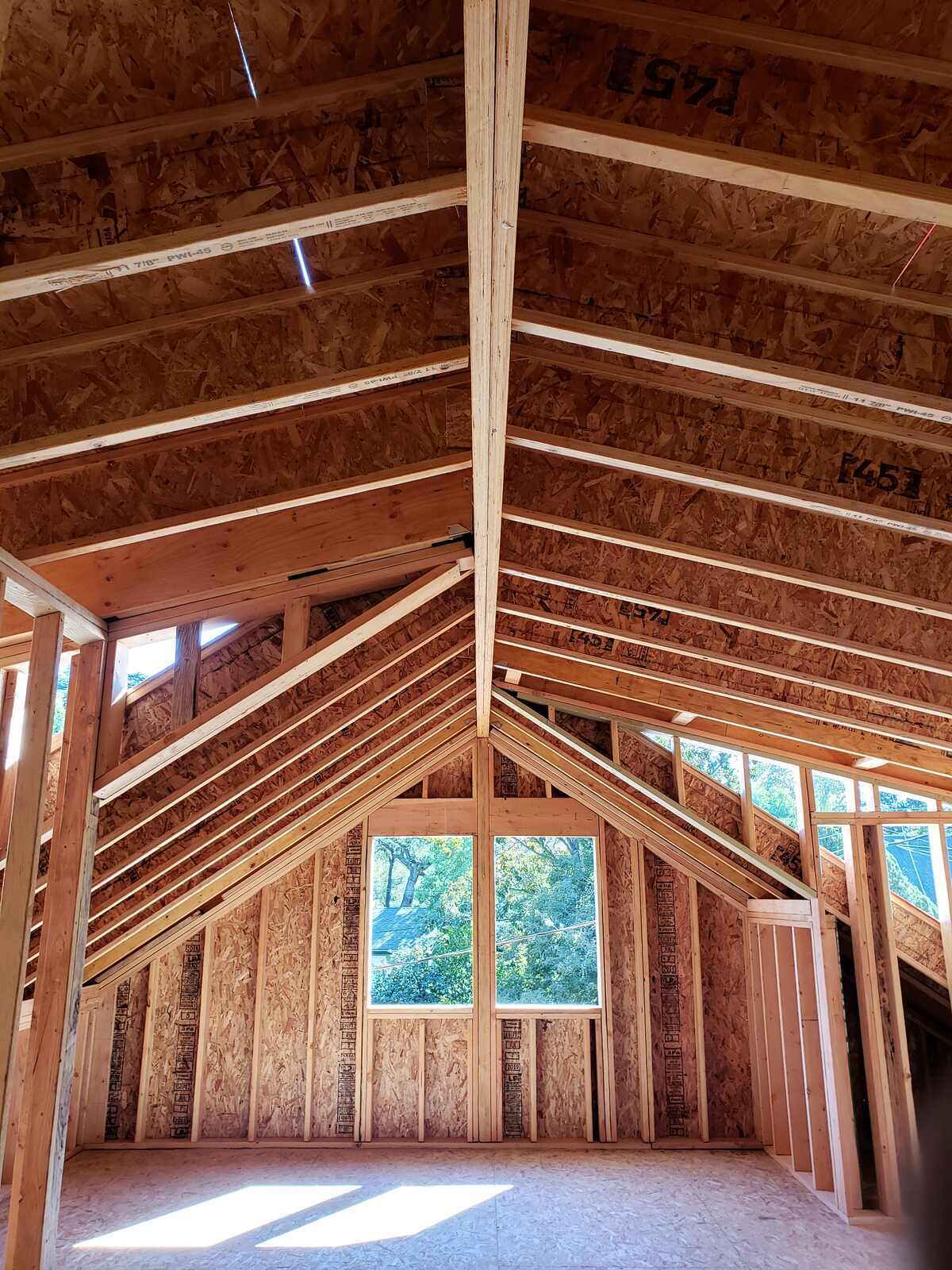 Interior framing of a home addition with large windows in Sacramento, CA by H&H Builds