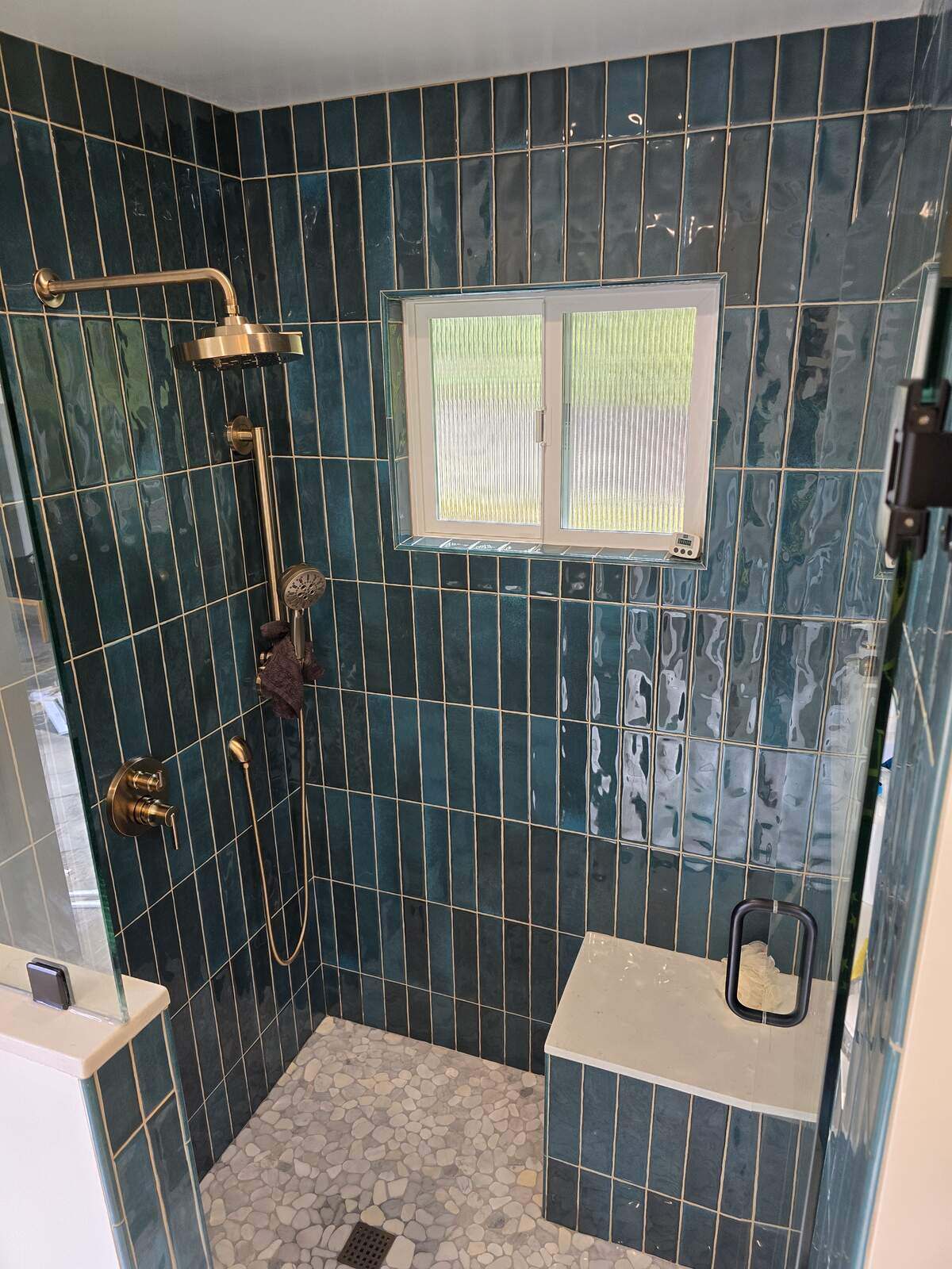 Custom walk-in shower with emerald green tiles, rainfall showerhead, and bench seating by H&H Builds, Sacramento, CA Custom walk-in shower with emerald green tiles, rainfall showerhead, and bench seating by H&H Builds, Sacramento, CA