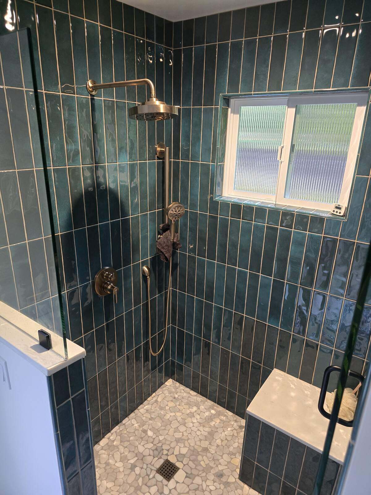 Double sink vanity with gold fixtures and round mirrors in remodeled bathroom by H&H Builds, Sacramento, CA