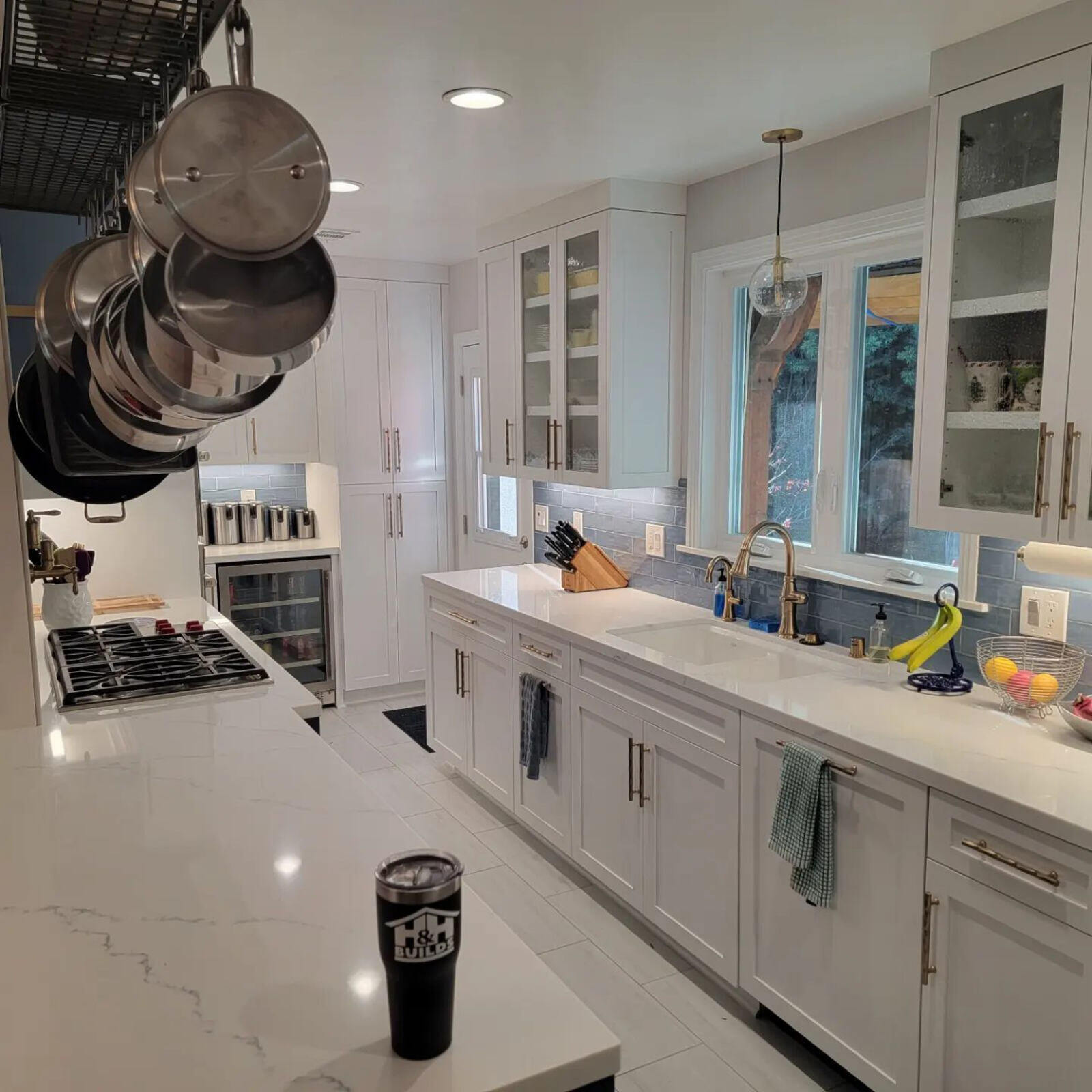 Modern kitchen remodel featuring white cabinets, marble countertops, and stainless steel fixtures by H&H Builds, Sacramento, CA